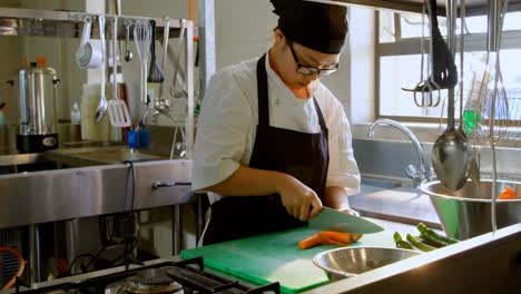 female chef cutting vegetables in kitchen 4k