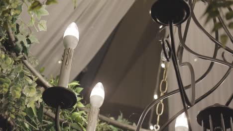 candles hang from ceiling at wedding