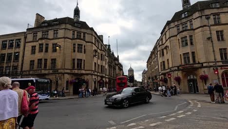 people and vehicles at a bustling intersection