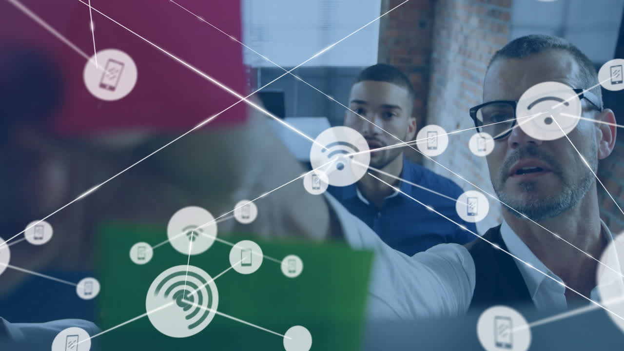 Collaborating business professionals with digital network and animation icons overlay