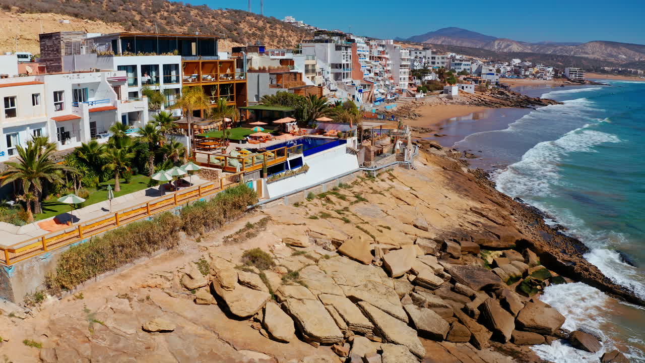 Aerial drone shot over the local beach town of Taghazout in Morocco.
