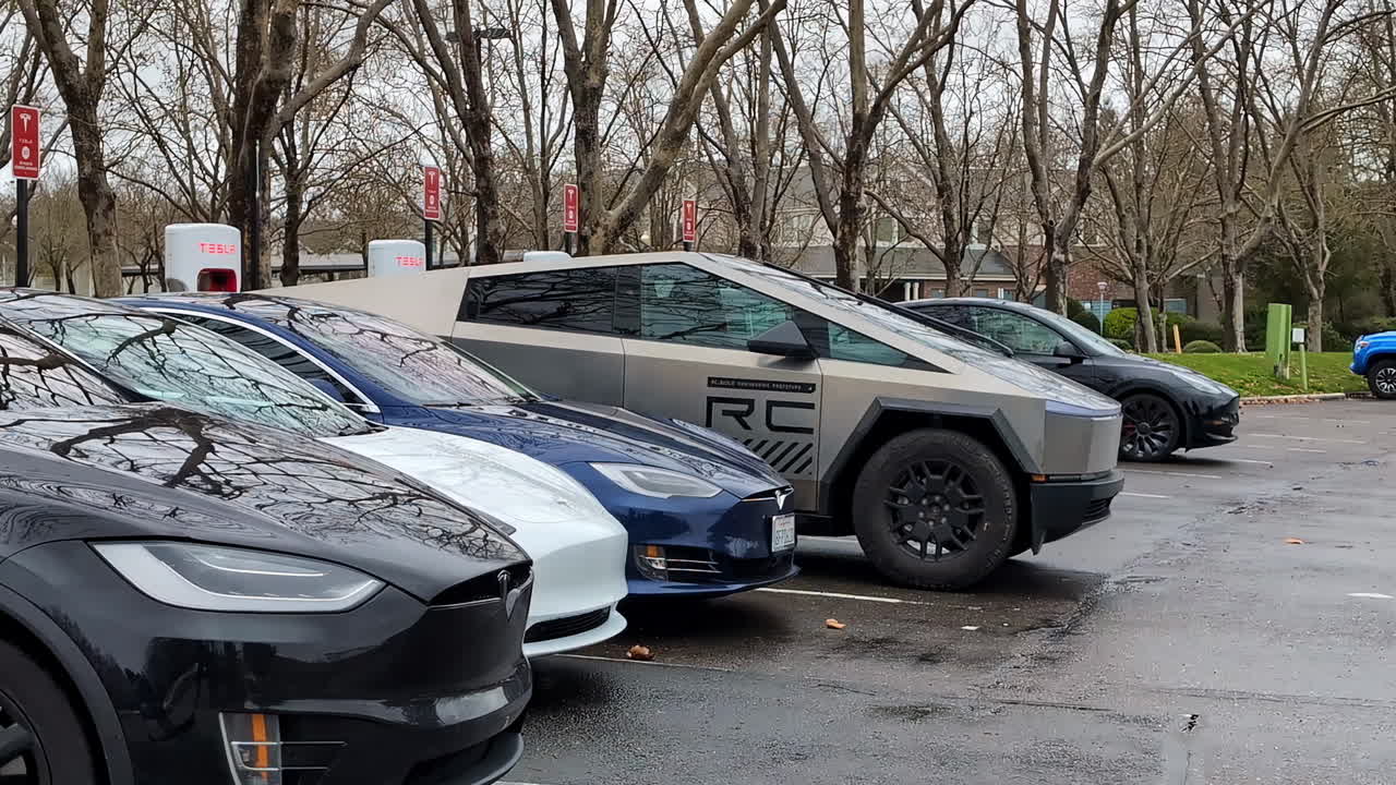 Tesla Cybertruck and other Tesla models parked at a charging station