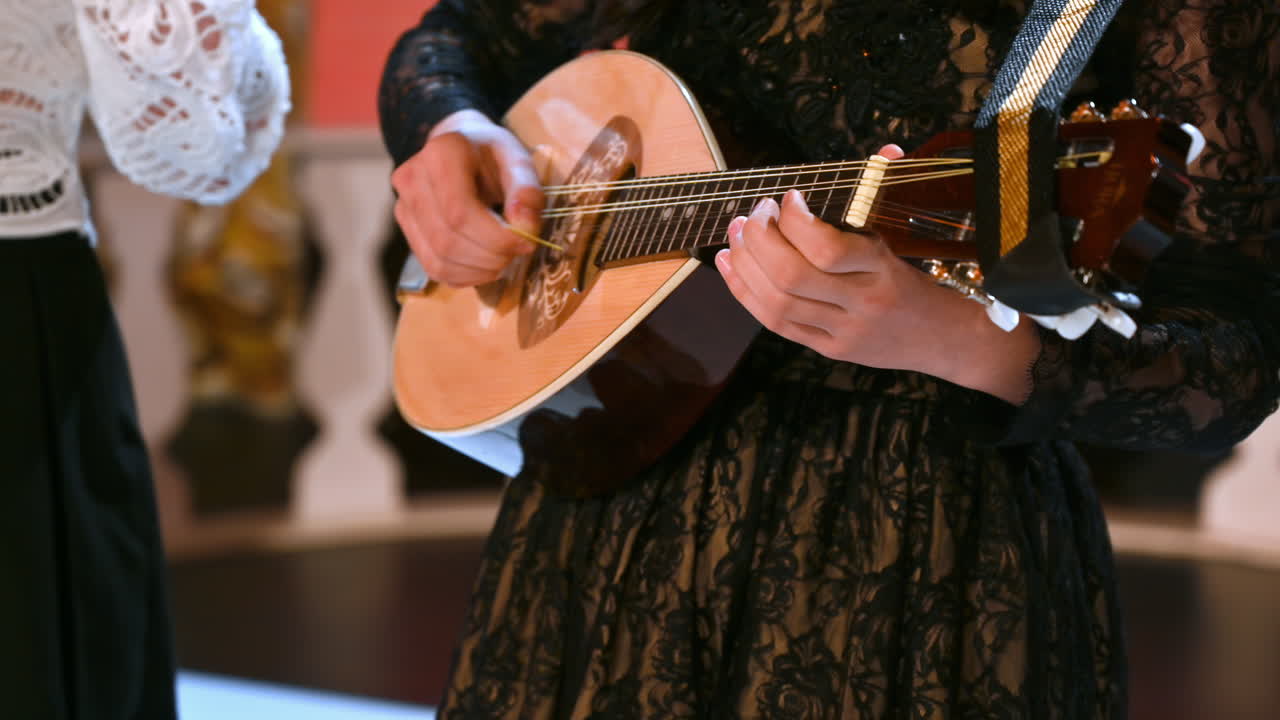 Close-up of two women playing the mandolin
