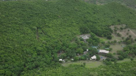 Aerial-pan-shot-of-Loterie-Farm-at-Saint-Martin-surrounded-with-greenery-in