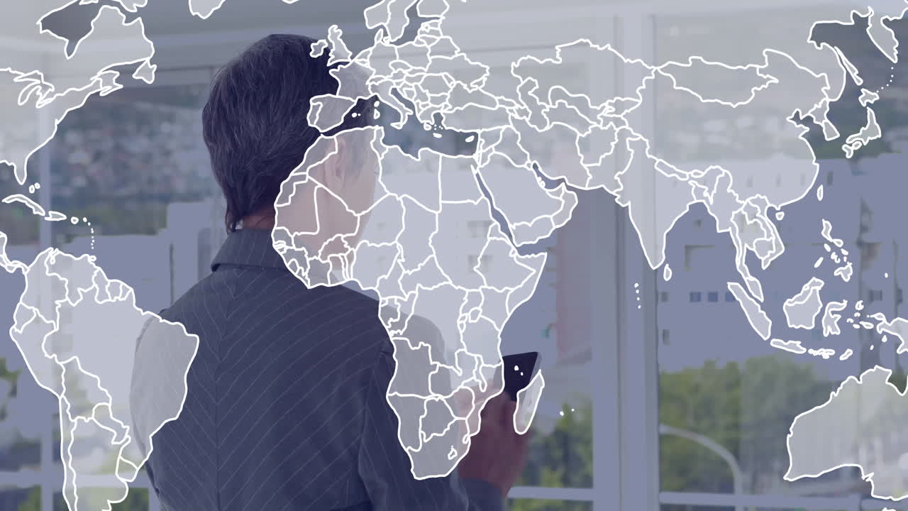 Holding smartphone with world map animation, businessperson in modern office setting