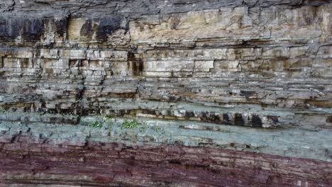 geological rock strata, colored stratified rock layers in the escarpment