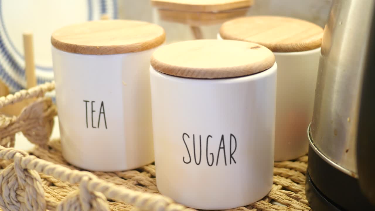 White Ceramic Tea and Sugar Canisters on Wicker Tray