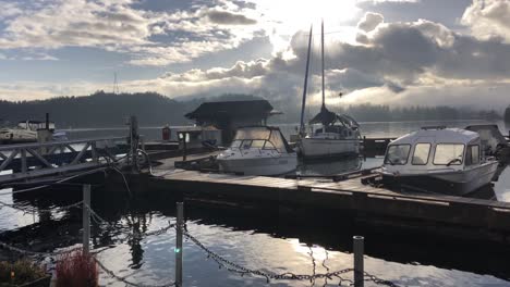 boats moored on water at marina in vancouver, panning long shot