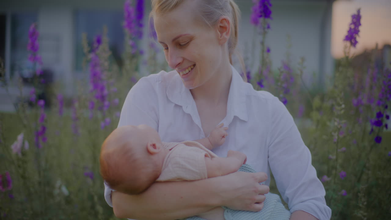 Yawning Baby in Mother's Arms