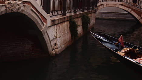 bow iron of a gondola cruising on the grand canal in venice, italy