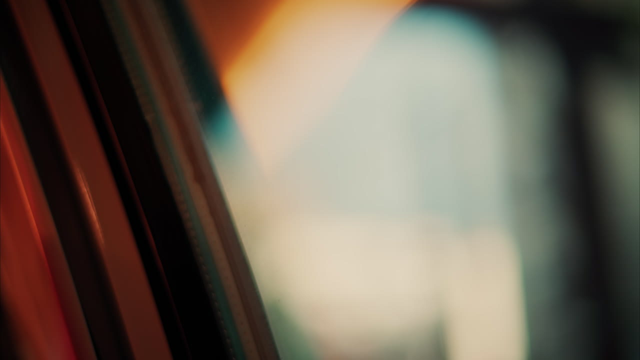 Close up of the window of a moving train with a blurry view