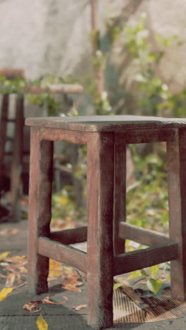 a rustic wooden stool in an outdoor setting.