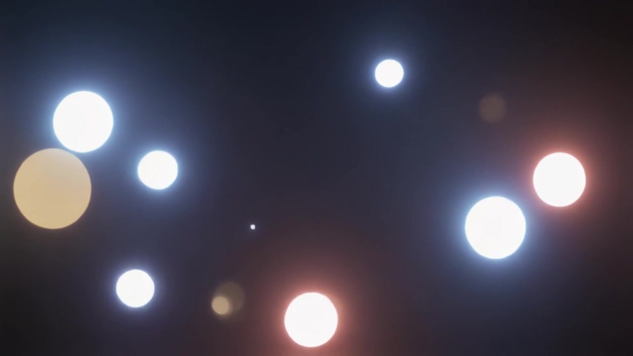 Abstract Motion of Glowing Bokeh Light Orbs on Dark Background
