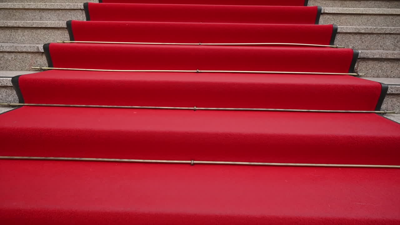Walking on red carpet stairs