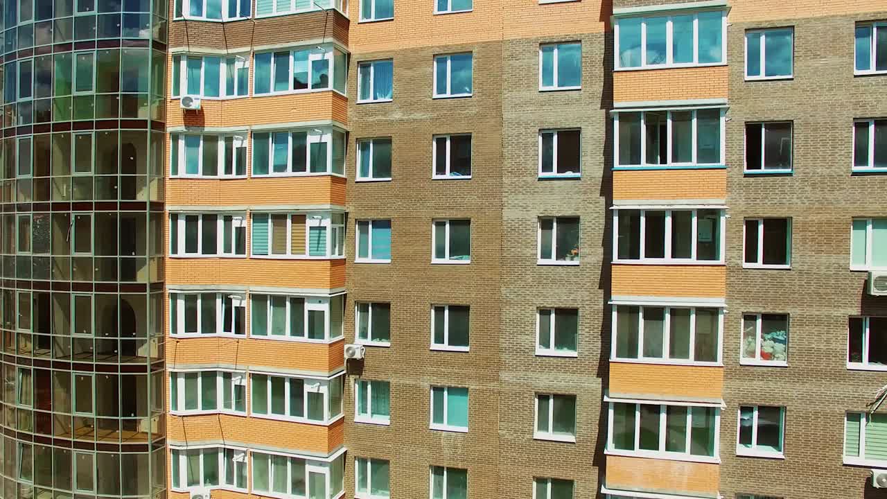 Architecture of urban background. New high-rise buildings with many windows and modern balconies. Tall apartments in the city.