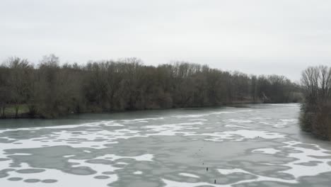 drone aerial footage of a 4k drone flying very close over a frozen lake in germany