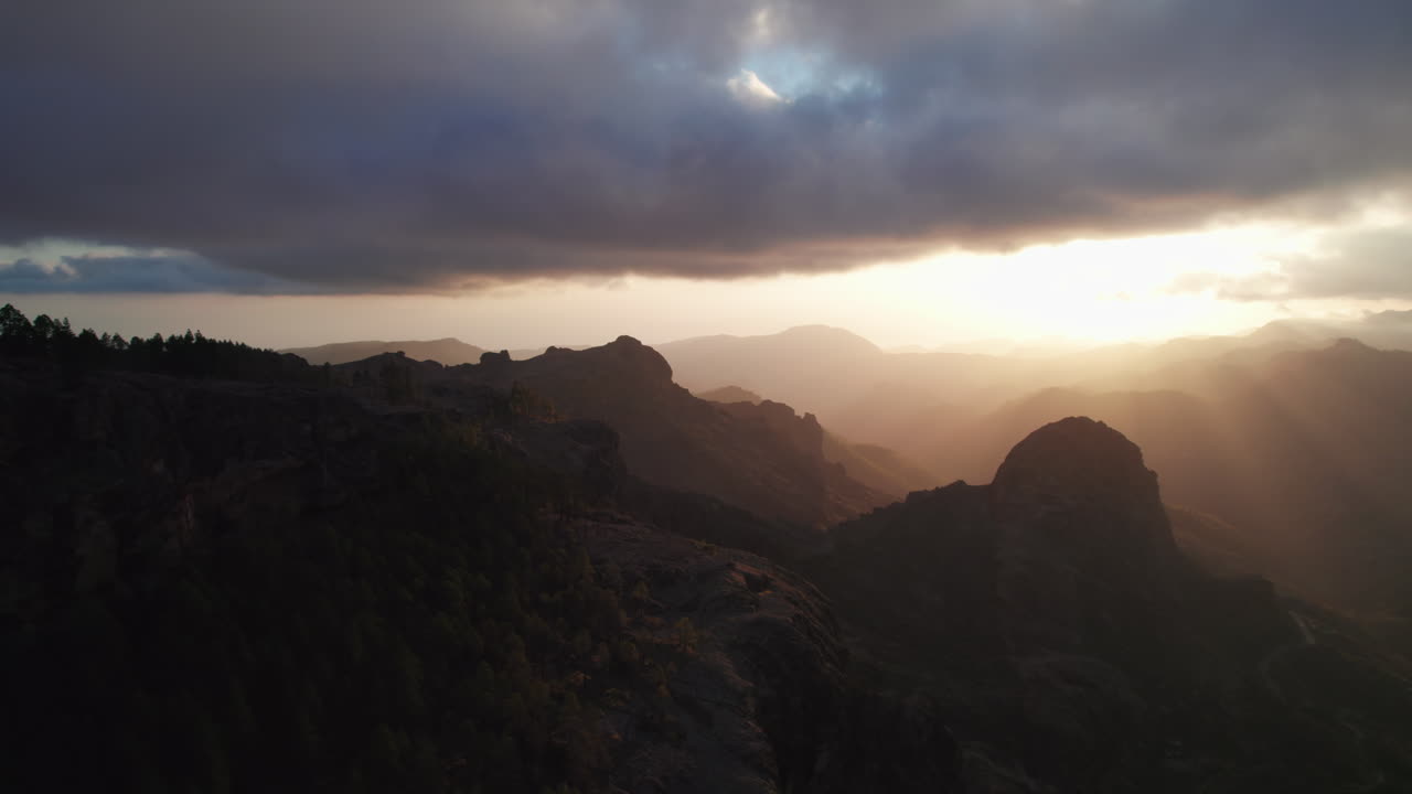 Sun rays filtering through clouds at sunset over Gran Canaria, Canary Islands, Spain