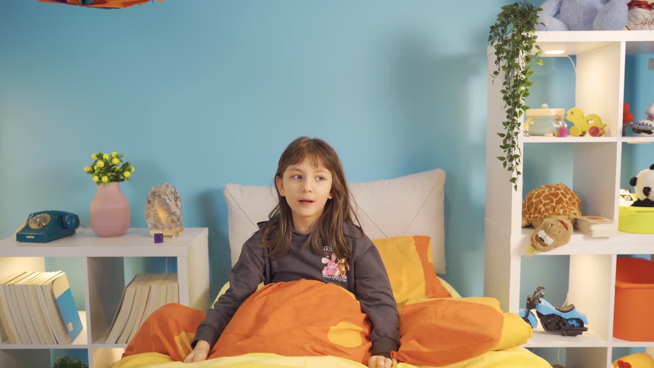 la niña que tuvo un sueño terrible se despierta de su cama con miedo.