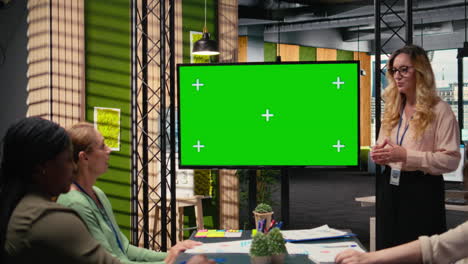 manager and staff members using copy space on tv monitor during meeting
