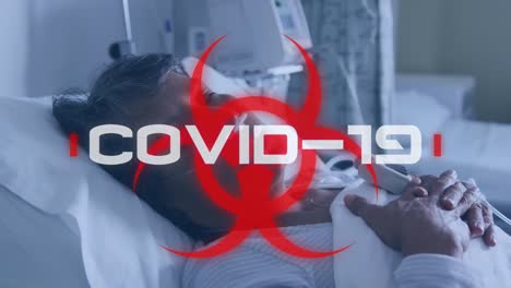 mundo covid-19 escrito sobre el signo de peligro para la salud y un paciente en el hospital. covid-19 extendiéndose