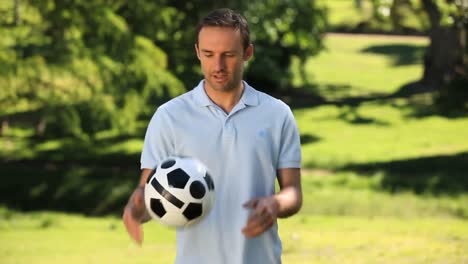 man smilling with a soccer ball