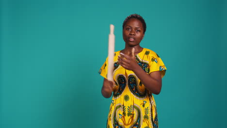 Strong-confident-woman-threatening-to-fight-with-a-rolling-pin