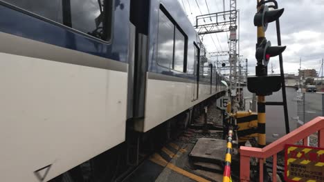 a train moves across a level crossing.