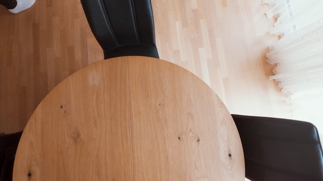 A man uses an unnecessarily large cardboard box to ship a small item. Symbolic of inefficient logistics, packaging waste, and the need for supply chain optimization or sustainability improvement