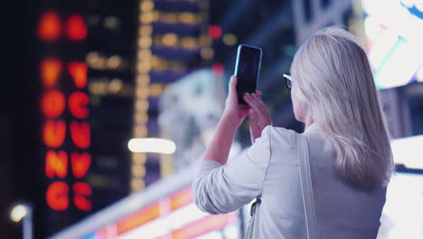 Woman-Tourist-Takes-Pictures-On-Times-Square-In-New-York-Tourism-And-Travel-In-The-Usa