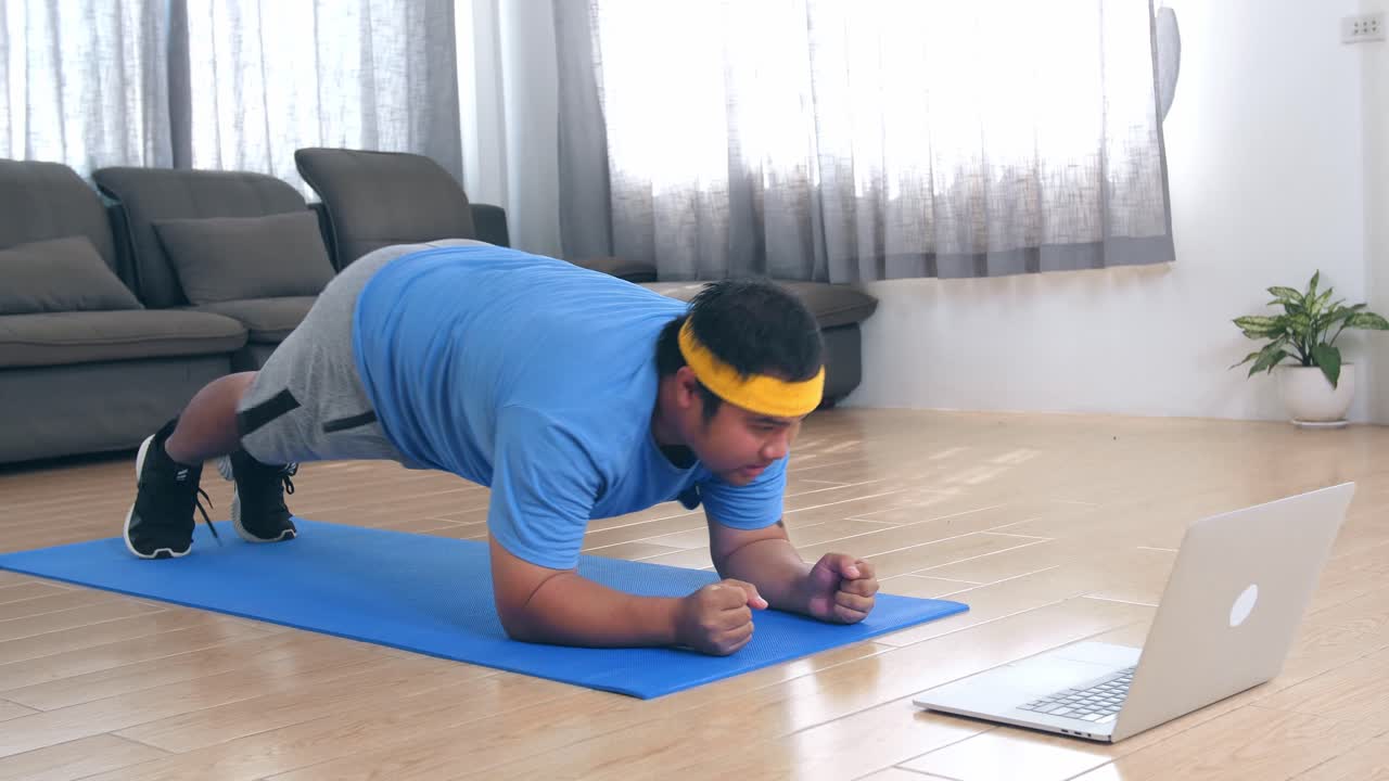 Overweight Man Doing Plank Exercise at Home