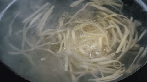 fresh pasta boiling in a pan of water