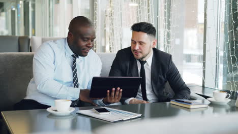 businessmen discussing in a cafe