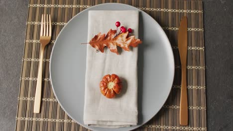 video of plate with autumn decoration lying on wooden mat