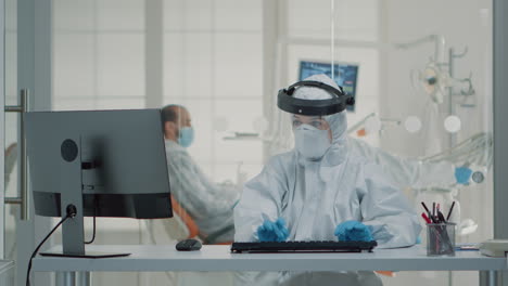 portrait of dental assistent typing on computer keyboard