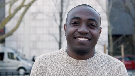 Closeup-view-of-cheerful-guy-standing-and-looking-at-camera