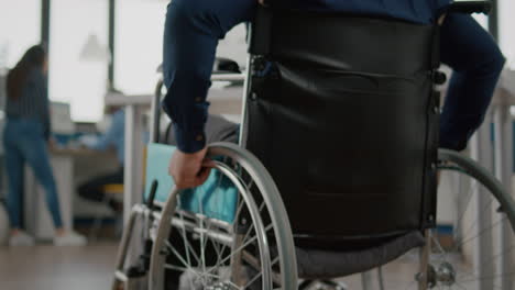 close up independence handicapped man in wheelchair entering in company