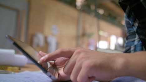 side shot of a man tapping on his tablet 4k