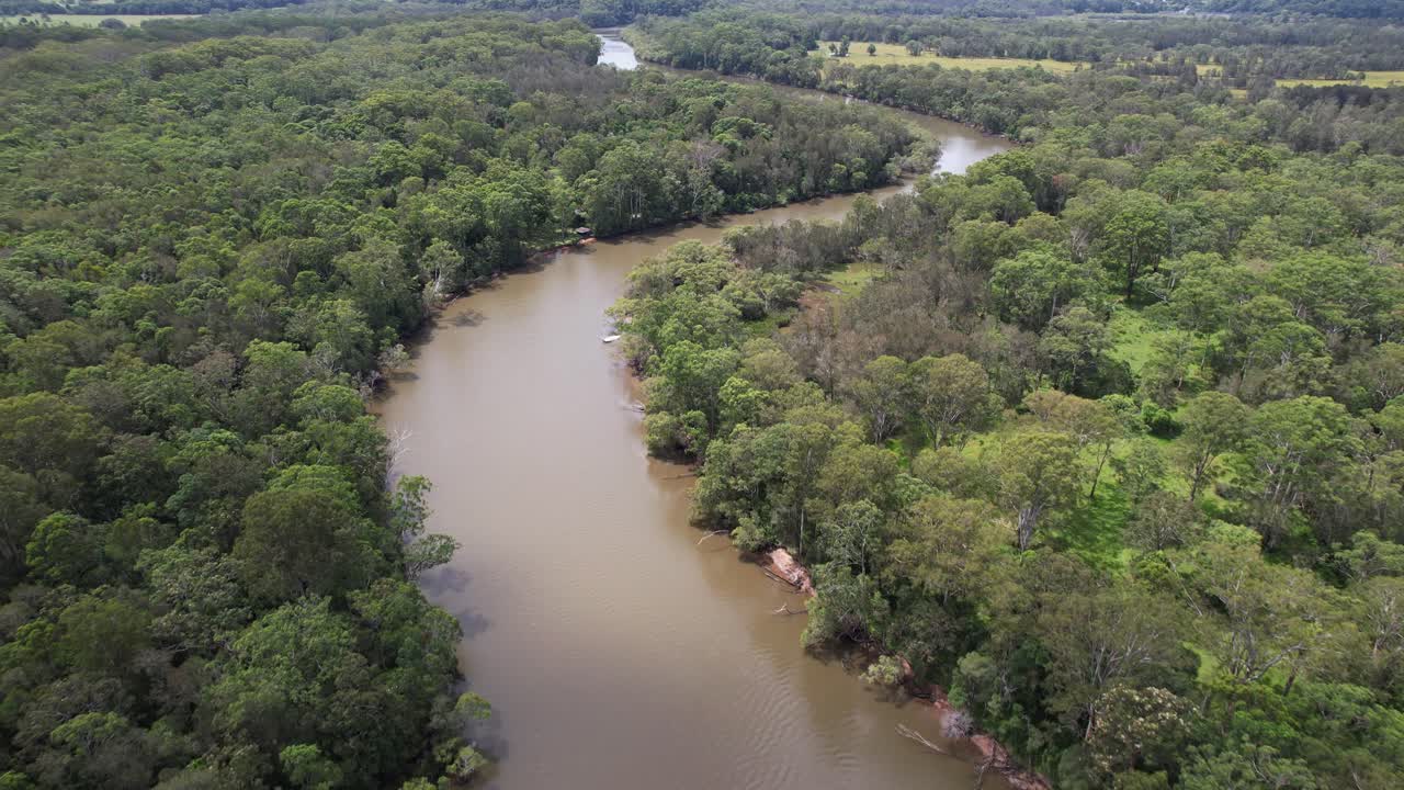 Brunswick River Surrounded By Dense Vegetation In New South Wales, Australia. aerial shot