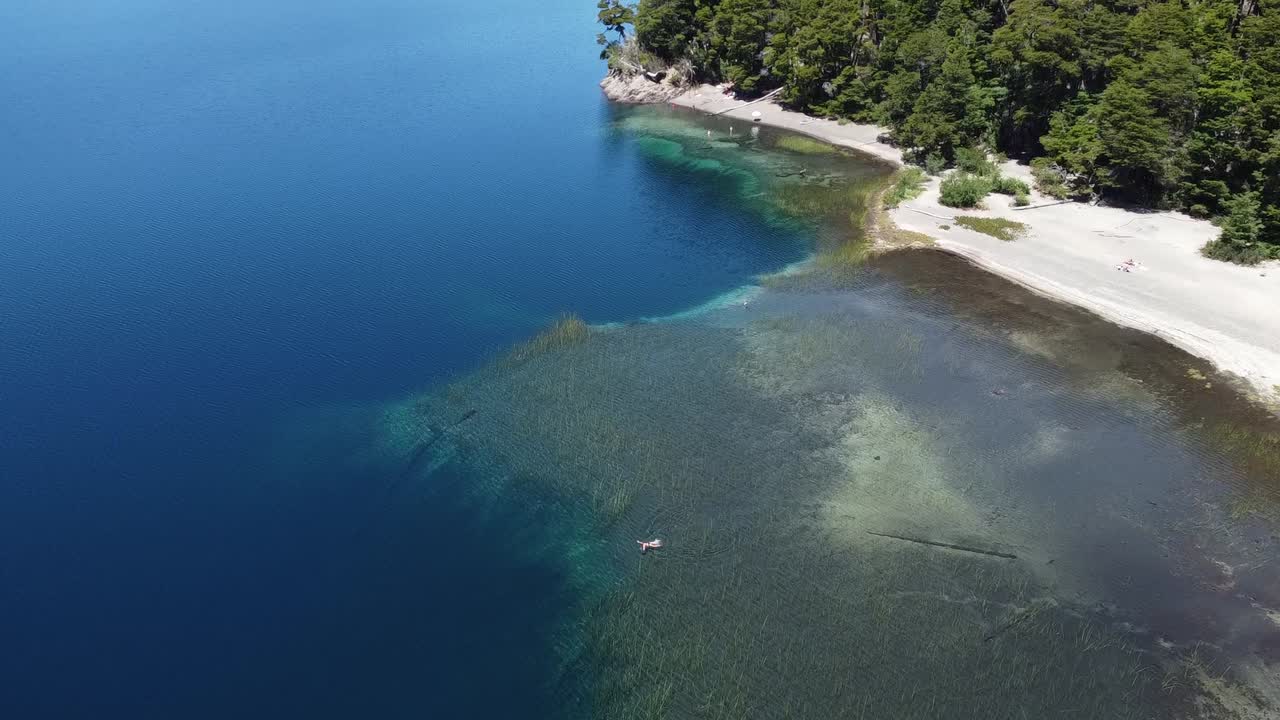 Woman swimming in a stunning lake in Patagonia Argentina