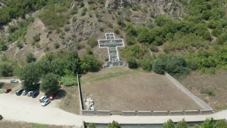 An-aerial-drone-pull-out-shot-of-a-cross-sculpture-for-the-consecration-of-St