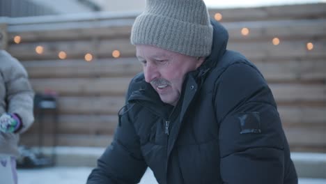 grandfather and granddaughter having fun in the snow