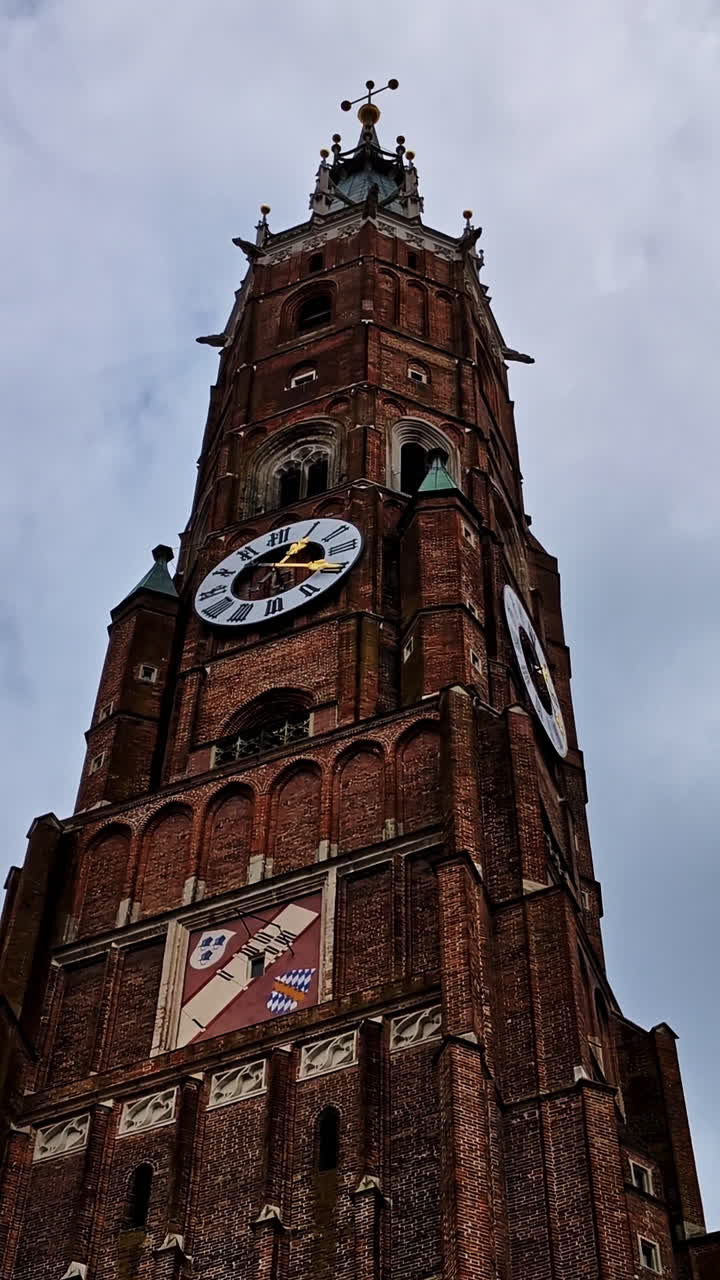 Clock tower of St. Martin’s Church in Landshut in closeup, vertical