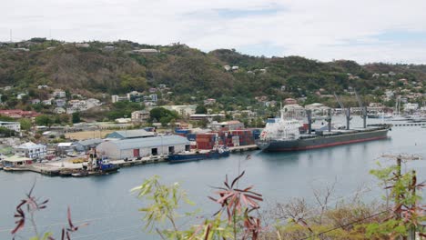 container ship in port on tropical island, grenada