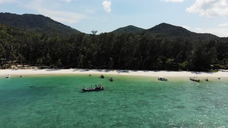 Following-sandy-beach-at-Ao-Chaloklum-Bay-in-Koh-Phangan,-Thailand,-with-a-Drone