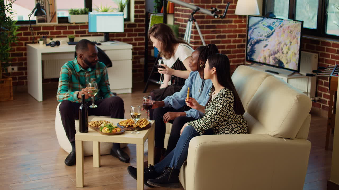 Multicultural colleagues doing social gathering in cozy apartment