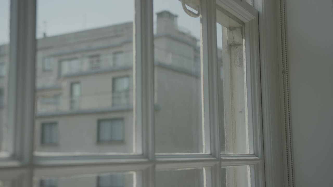 A 5K shot of a London building seen through a window.