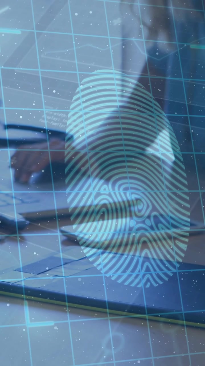 Animation of biometric over hands of caucasian businesswoman using laptop and graphics tablet