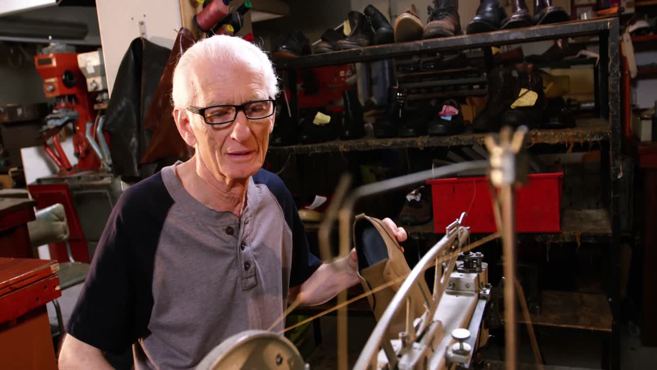 Shoemaker examining a shoe