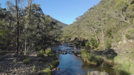 aerial shot moving forward over a river in the victorian high country