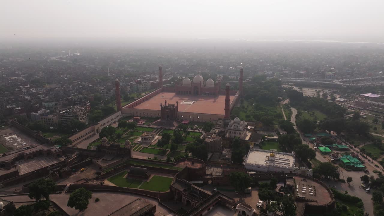 Aerial Drone Shot Above Lahore Fort, Badshahi Mosque on Smoggy Day in City. (Imperial Mosque or Lahore Mosque)